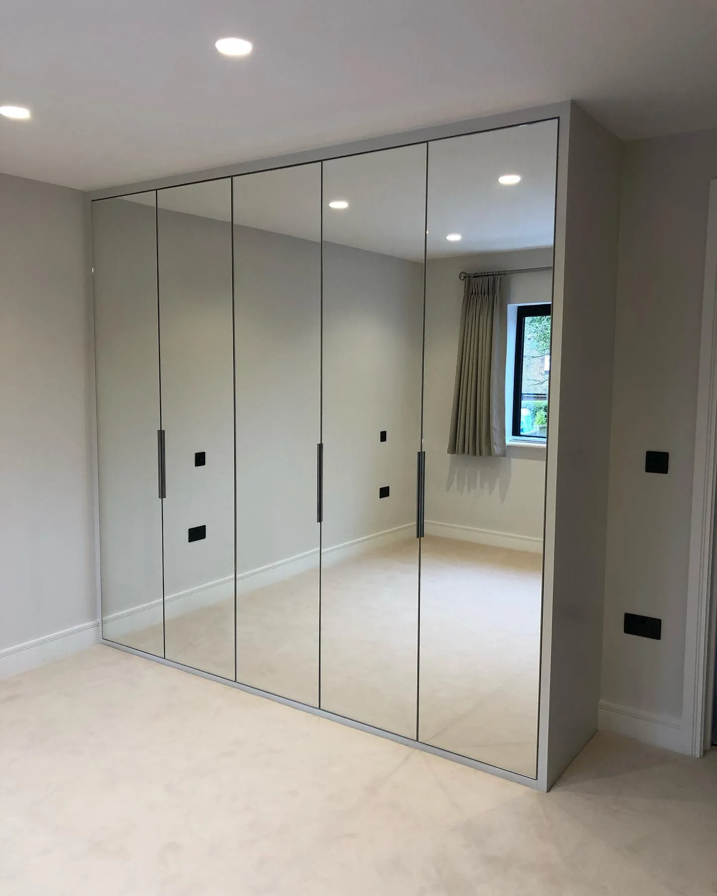 an empty room with a large mirrored closet
